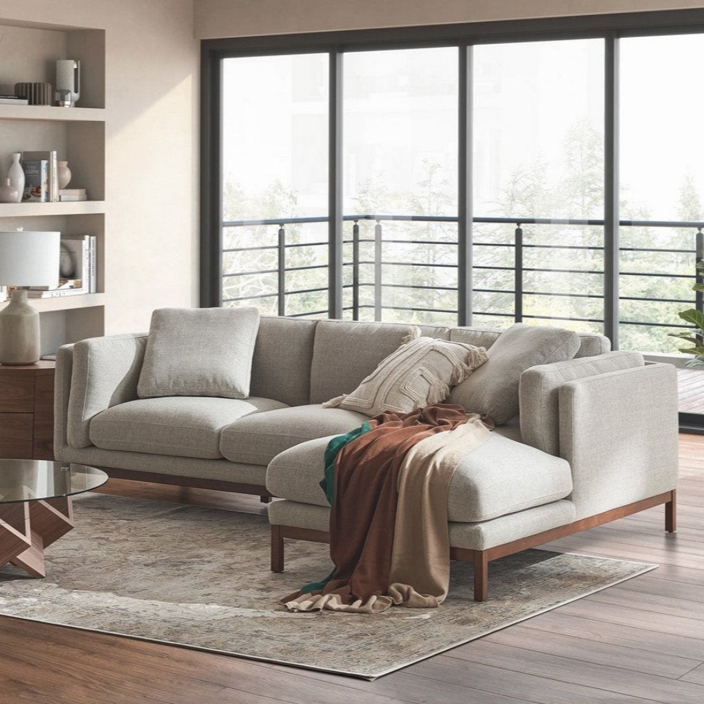 Modern beige chaise sectional sofa with wooden legs in a living room