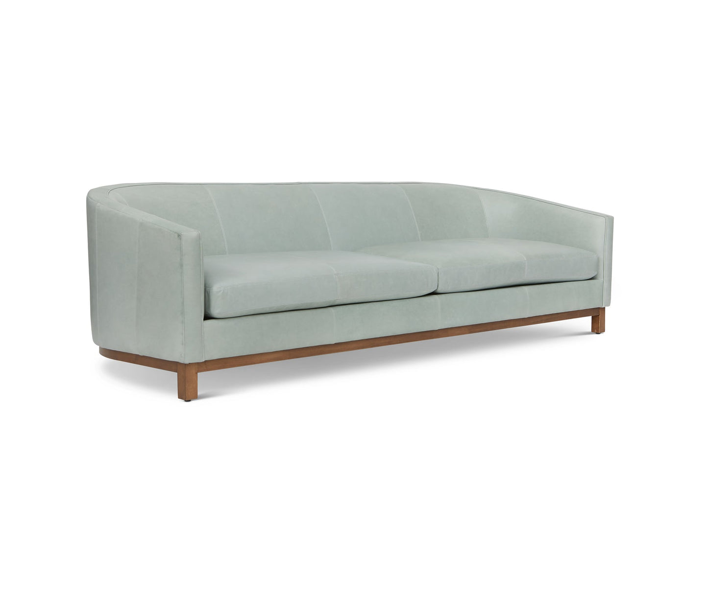 Introducing the Pippa Sofa in Mediterranean, a contemporary light green sofa featuring a curved backrest and a wooden base. This minimalist-style piece comes with three seat cushions and sleek armrests, beautifully showcased against a white backdrop.