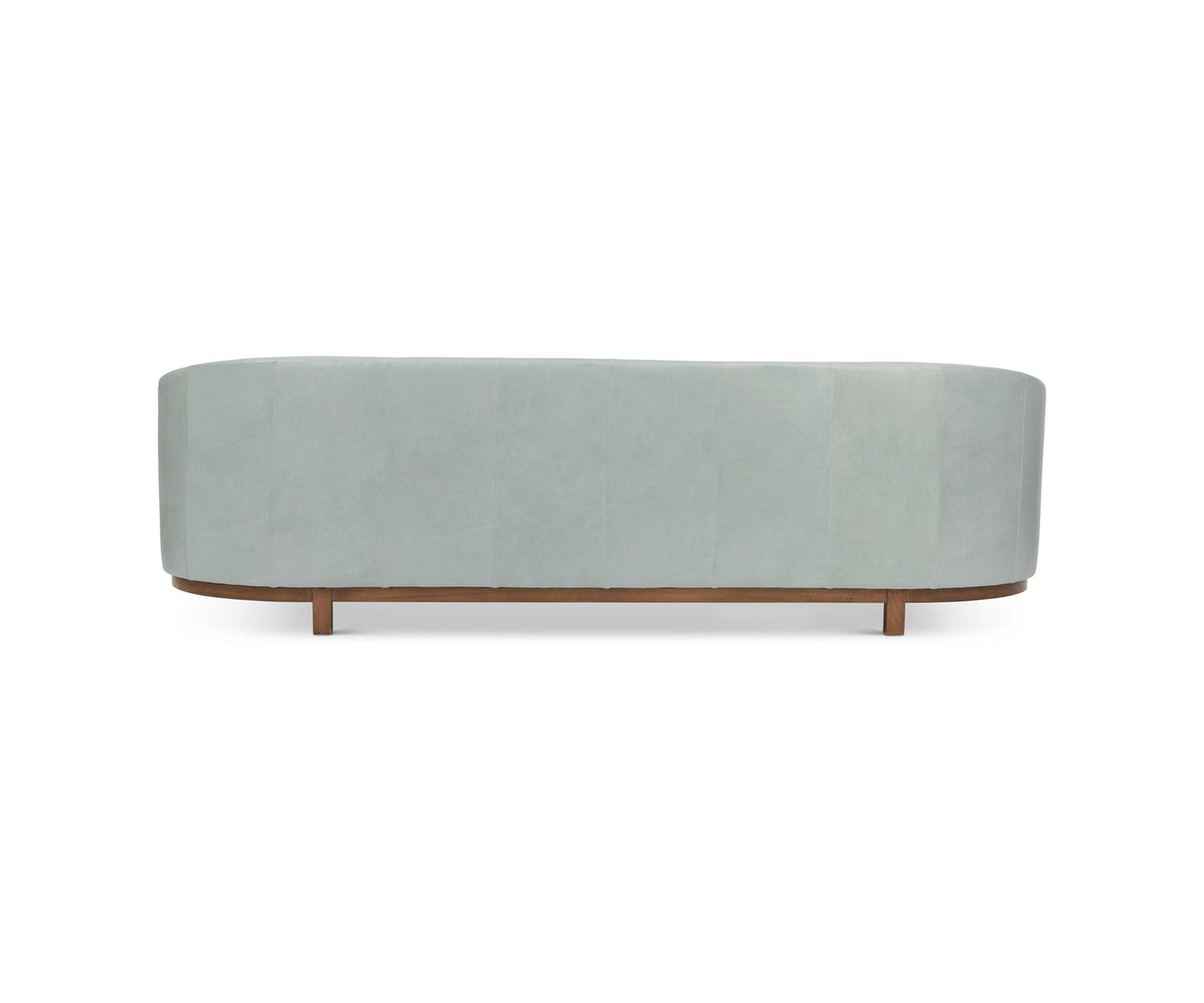 The back view of the Pippa Sofa in Mediterranean showcases its modern light blue upholstery and wooden base. The design is minimalistic, featuring smooth curved lines with no visible details. It is set against a plain white background.