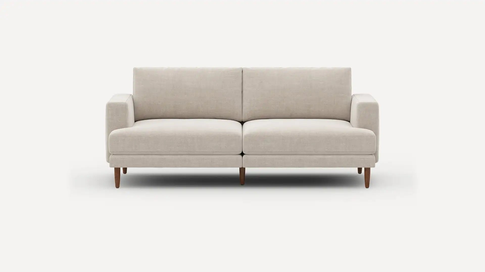 Introducing the Ember Mid-Century Modern 75" Sofa— a contemporary light beige piece showcasing clean lines and a minimalist design. This sofa features two seat cushions and two back cushions, complemented by low armrests and wooden legs, all set against a plain white background.