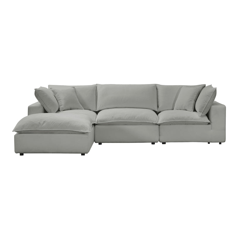 The Cali Performance Fabric Modular 4 Piece Sectional is a light gray sofa featuring an attached chaise on the left side. It boasts thick cushions and multiple pillows, offering a plush and comfortable appearance against a plain white background.