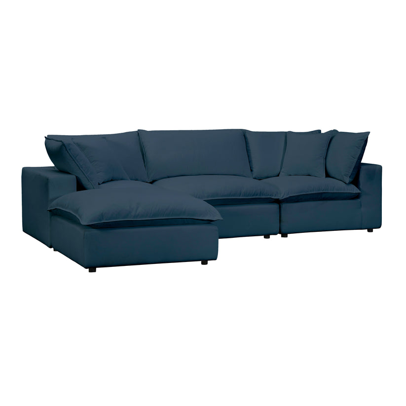 The Cali Performance Fabric Modular 4 Piece Sectional is a dark blue L-shaped sofa with large cushions and plush seating, designed for both comfort and style. It includes an extended chaise on the left side, perfect for lounging.