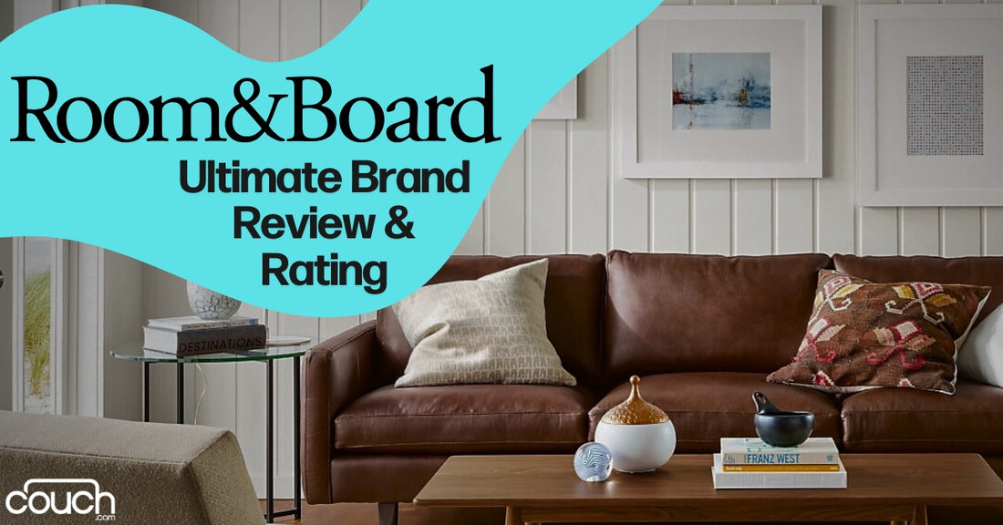 A cozy living room with a brown leather sofa, patterned and textured pillows, and a wooden coffee table with decorative items. The wall is adorned with framed artwork. The text reads: "Room&Board Ultimate Brand Review & Rating" on a blue background.