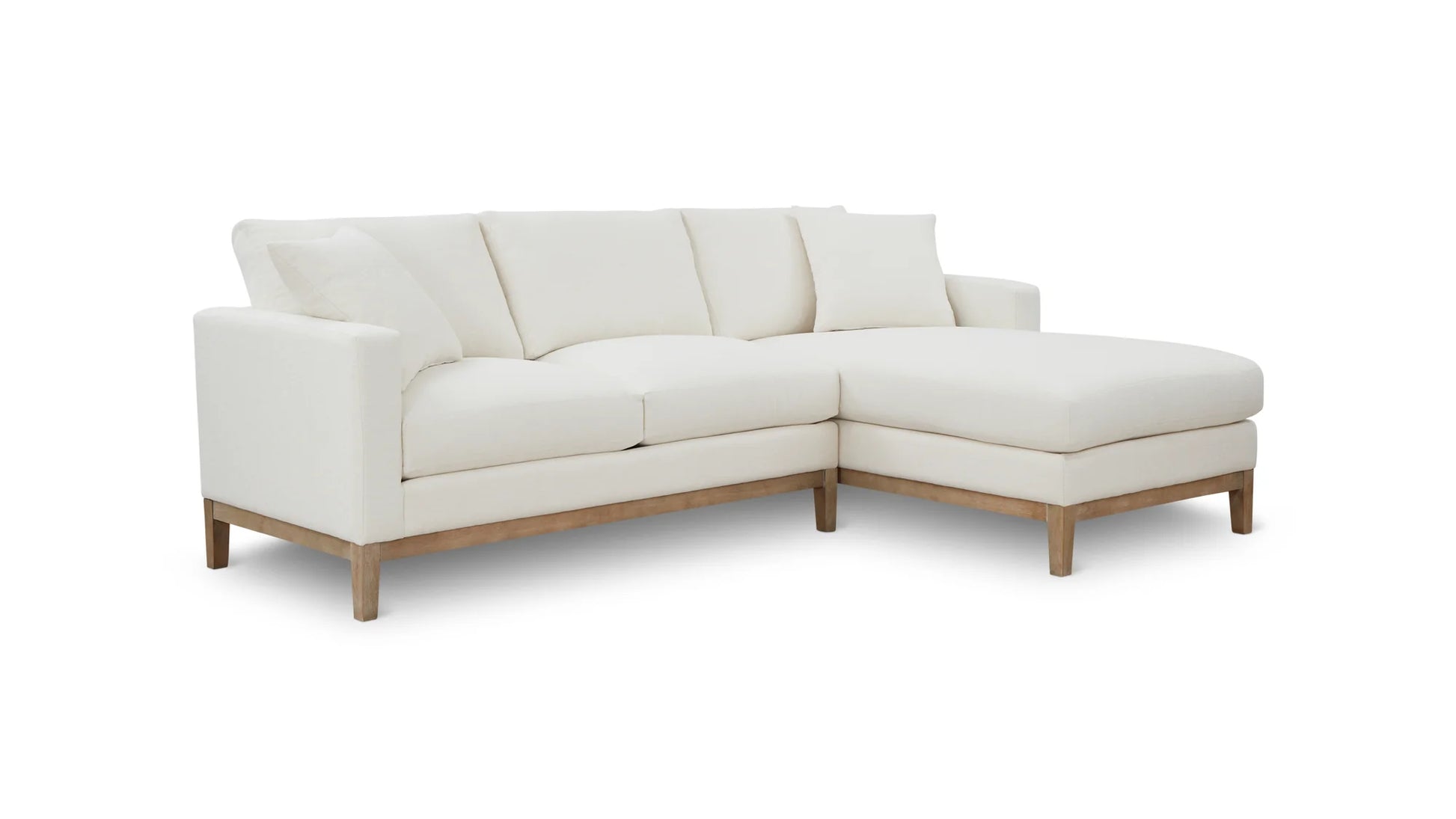 Introducing the Any Day Sectional: a contemporary white sectional sofa with a right-side chaise lounge, featuring sleek lines and wooden legs, elegantly displayed against a simple white background.