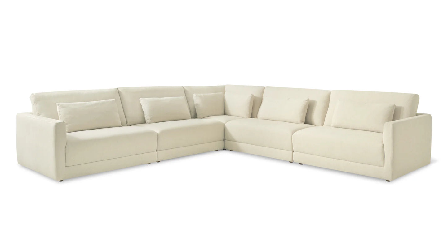 A spacious and comfortable Wind Down 4-Piece Modular Sectional in a large L-shape, featuring plush cream-colored cushions and clean, simple lines, set against a plain white background.