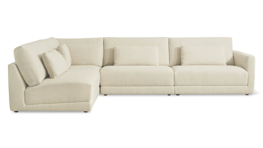 The Wind Down 4-Piece Modular Sectional is a spacious, L-shaped beige sofa with plush cushions set against a white background.