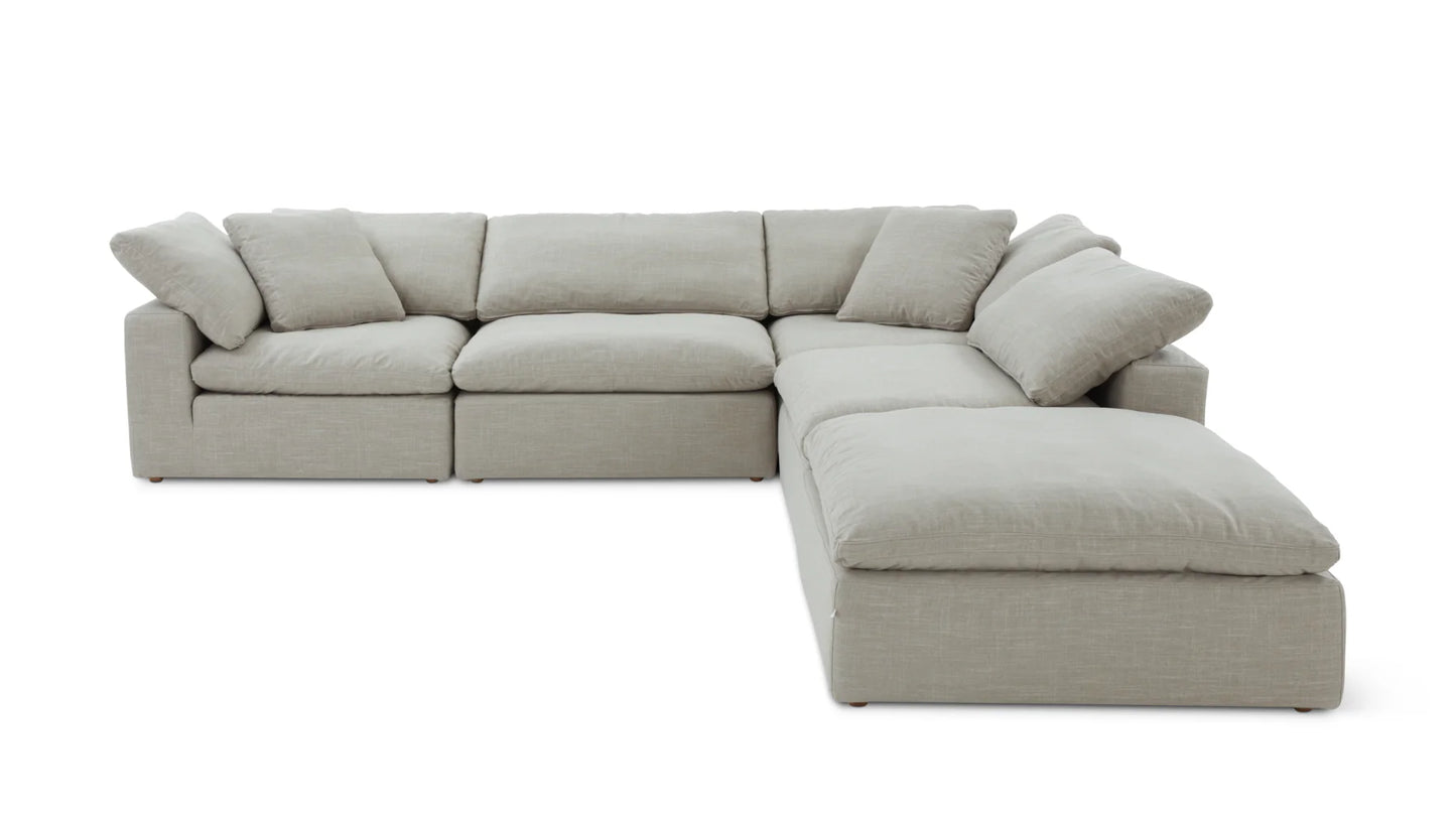 The Movie Night 3-Piece Modular Sofa is a light gray sectional featuring plush cushions and an L-shaped design with three seating sections and a chaise lounge, offering a spacious and modern setup for your living room against a white backdrop.