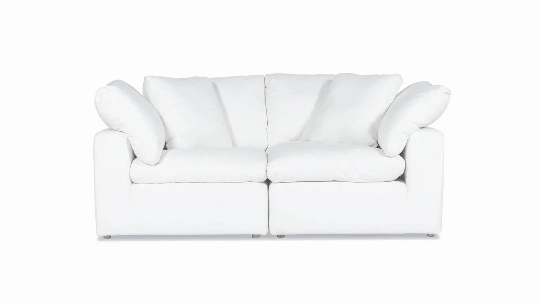 A Movie Night 3-Piece Modular Sofa in white, featuring plush cushions and a contemporary design, set against a plain white background. This cozy sofa offers seating for two and includes four large cushions for added comfort.