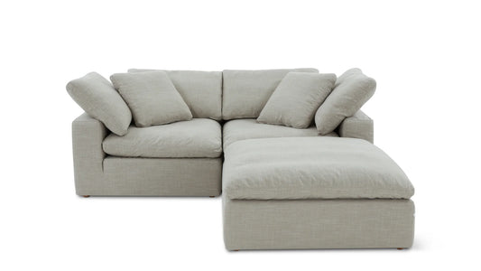 The Movie Night 3-Piece Modular Sofa is styled in a contemporary L-shape with a chaise lounge on the right. It features a light gray color, plush cushions, and a minimalist design, all showcased against a simple white backdrop.