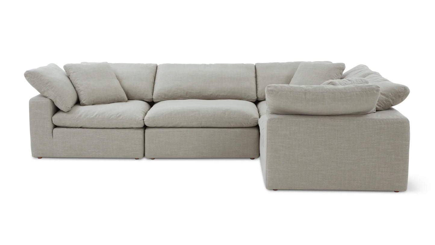 The Movie Night 3-Piece Modular Sofa, featuring soft and textured light gray fabric with plush cushions, is set up in an L-shape. This modern and minimalist sectional sofa comprises multiple sections that can be easily rearranged.