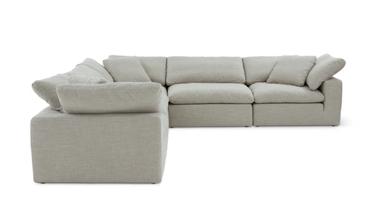 Introducing the Movie Night 3-Piece Modular Sofa, a light gray sectional that boasts an L-shaped design with thick cushions. This sofa exudes modern minimalism, featuring fabric upholstery and plush back and seat cushions that offer an invitingly cozy seating experience.