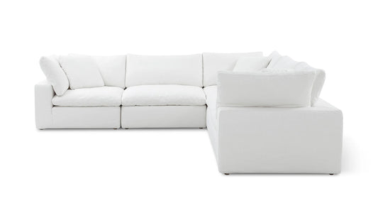 The Movie Night 3-Piece Modular Sofa, featuring plush cushions and a minimalist design, is arranged in an L-shape. It boasts a soft fabric finish and stands out against a plain white background.