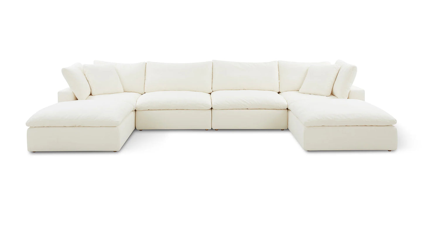 The Movie Night 3-Piece Modular Sofa, an expansive white L-shaped sectional with plush cushions, is set against a simple backdrop. Its modern and minimalist design features deep seating and padded armrests, creating a cozy and inviting look.