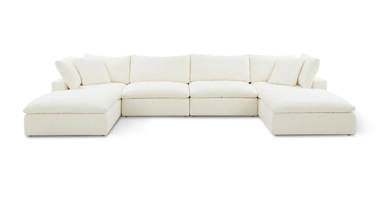 The Movie Night 3-Piece Modular Sofa, an expansive white L-shaped sectional with plush cushions, is set against a simple backdrop. Its modern and minimalist design features deep seating and padded armrests, creating a cozy and inviting look.