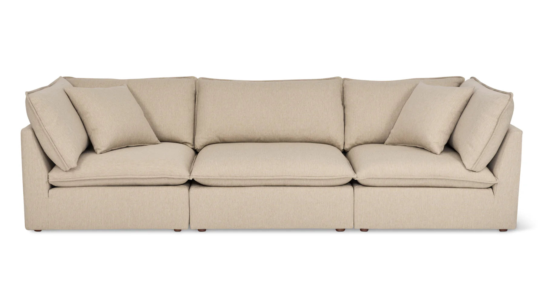 Experience the Chill Time 4-Piece Modular Sectional, a modern beige sofa with plush cushions arranged in three seating sections. It features two matching throw pillows on either side and boasts a clean, minimalist design on a white background.