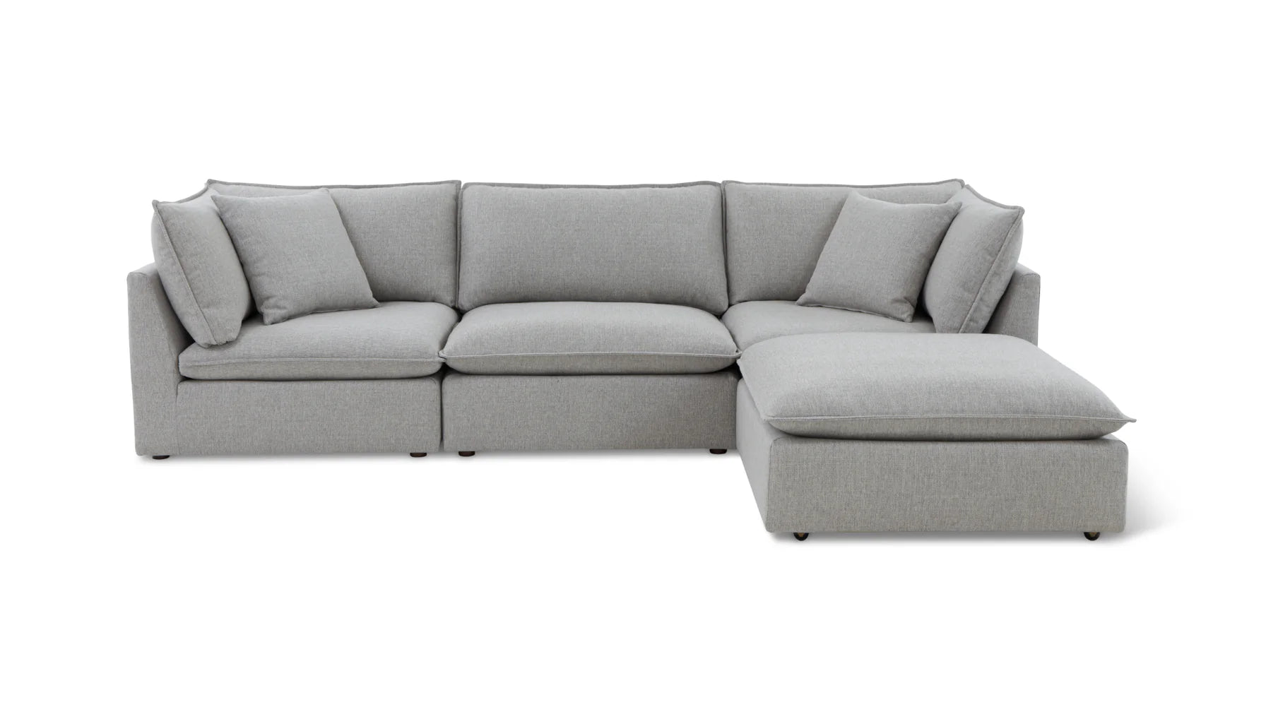 The Chill Time 4-Piece Modular Sectional, featuring a light gray hue and plush cushions, is arranged in an L-shape on a white background. It showcases a modern design with a chaise on the right side, offering ample seating space.