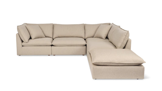 The Chill Time 4-Piece Modular Sectional is a beige L-shaped sofa with six cushions, featuring a modern and minimalist design. It has multiple modular pieces, a low backrest, and offers a spacious seating area, making it perfect for a living room setting.