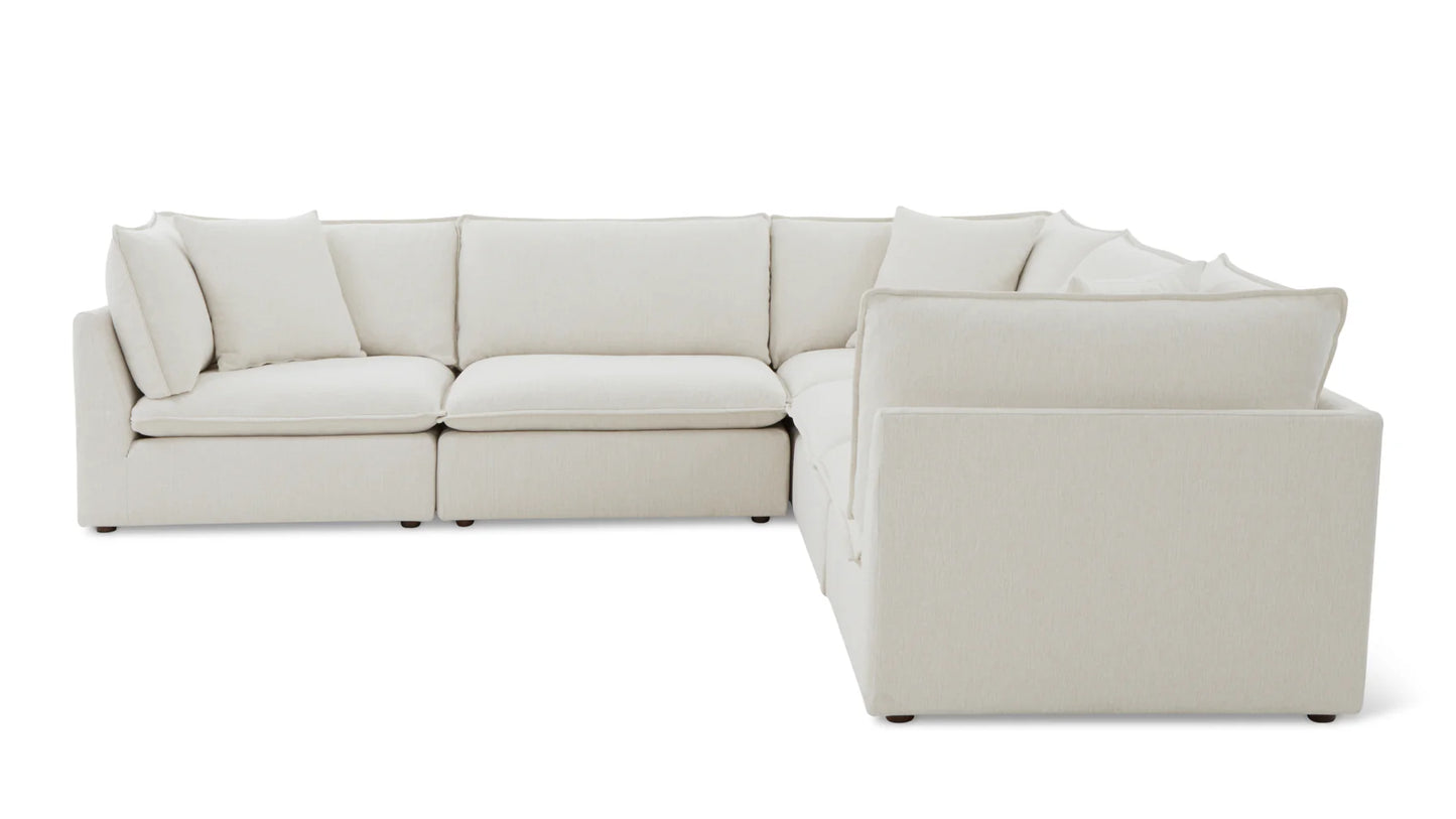 The Chill Time 4-Piece Modular Sectional features an extensive L-shaped design with cushioned seats and backrests, showcasing simple, clean lines on a white background. Its off-white hue and modular arrangement make it a perfect blend of style and comfort.