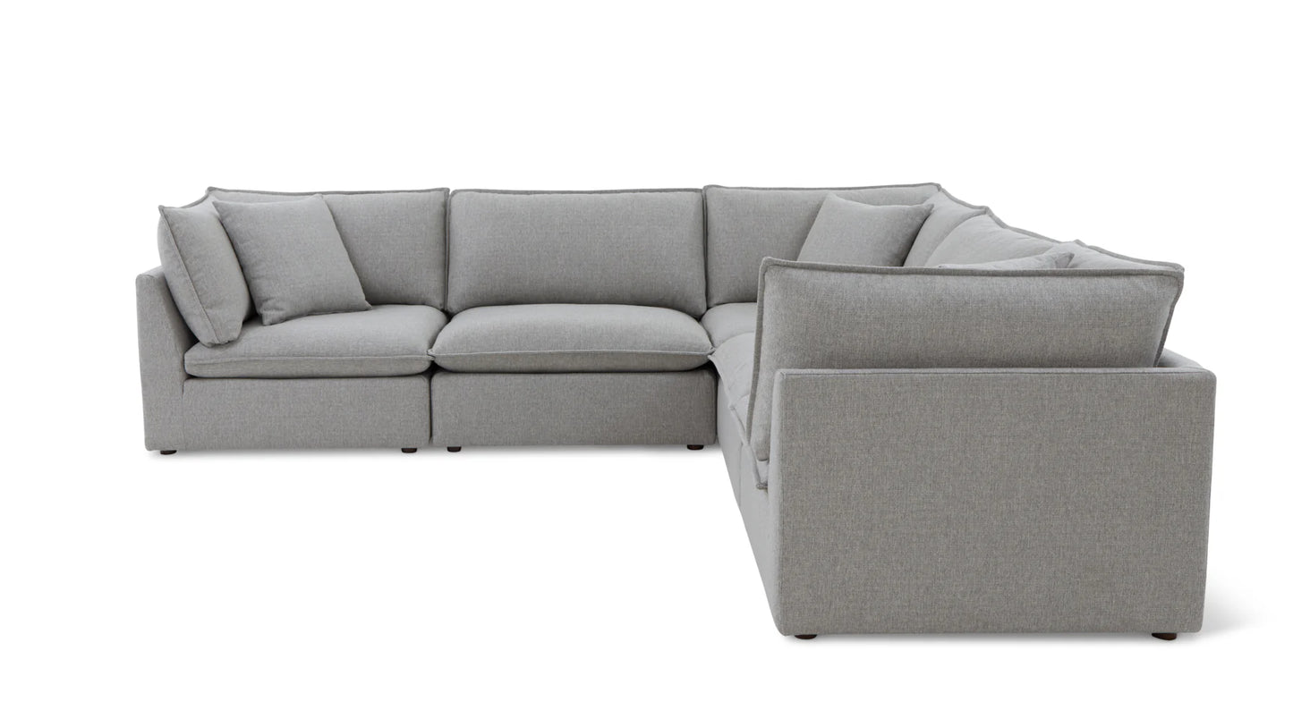 The Chill Time 4-Piece Modular Sectional is a modern, light gray sofa featuring clean lines and plush cushions. Arranged in an L-shape against a white background, it highlights its minimalist design.