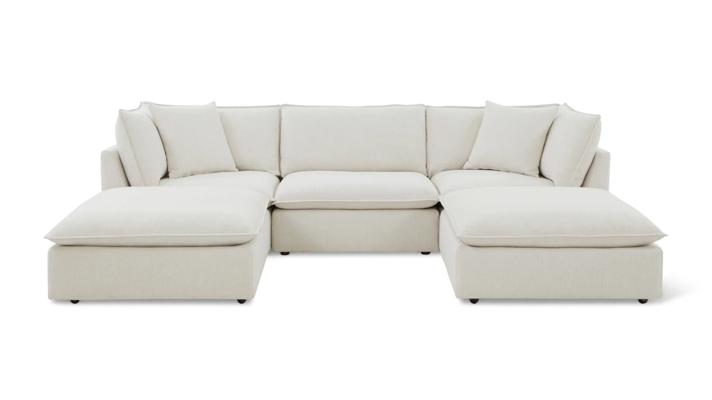 The Chill Time 4-Piece Modular Sectional is a spacious, beige sofa featuring a U-shaped design. It boasts plush cushions and a minimalist style, beautifully presented against a plain white background.