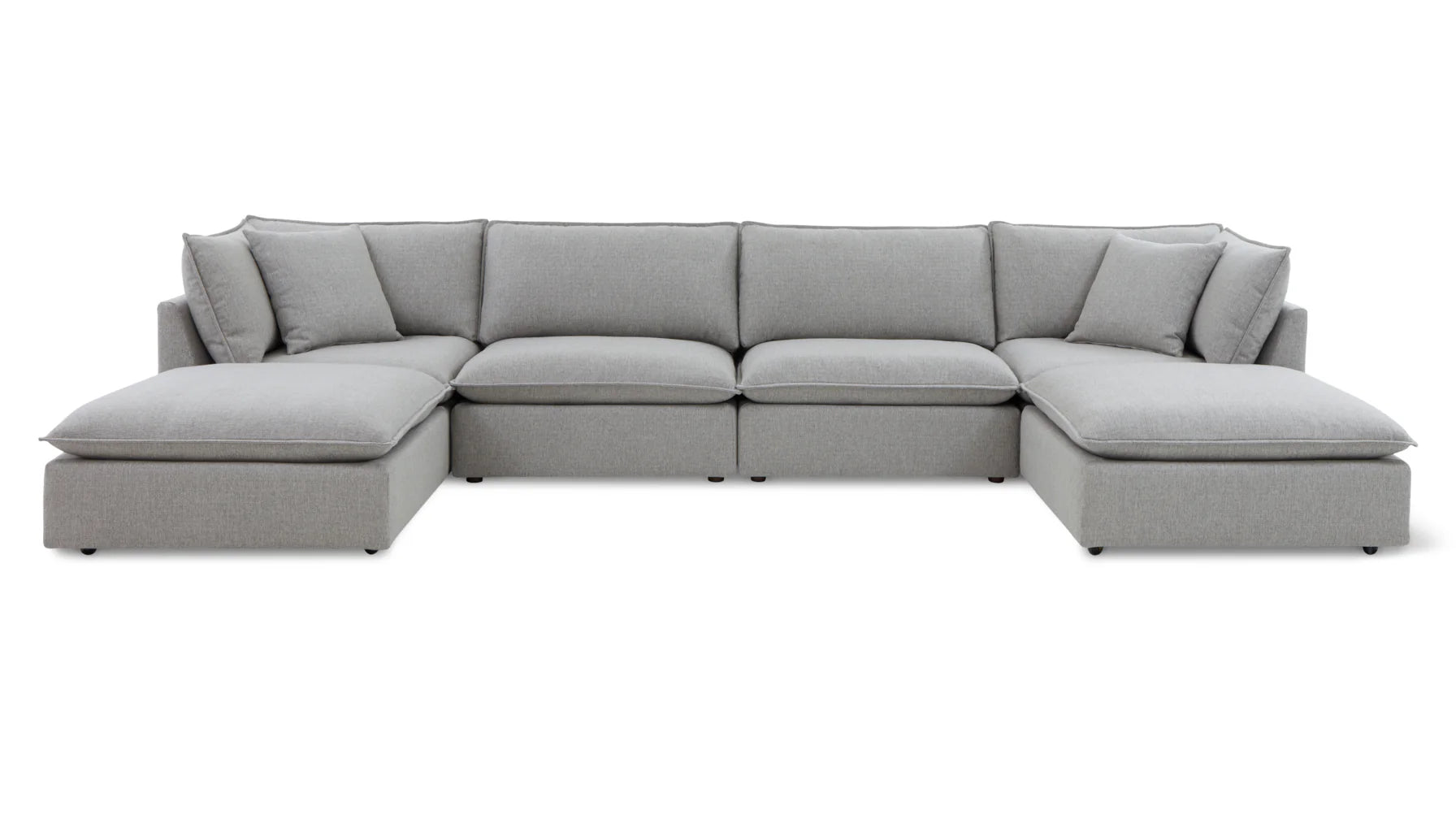 The Chill Time 4-Piece Modular Sectional, featuring a modern design in a large, light gray hue, is arranged in an L-shape. It offers plush cushions and wide seating for optimal comfort, set against a plain white background.