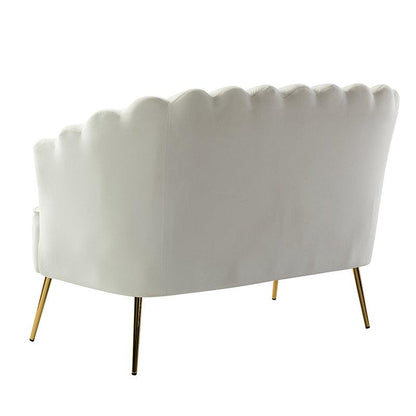 The rear view features the Ariel Scalloped Loveseat, showcasing its modern and elegant design with smooth white velvet upholstery, a scalloped backrest, and gold metal legs.