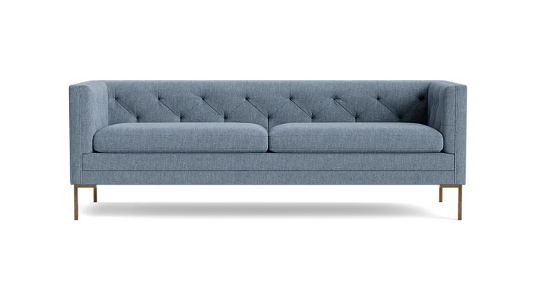 The Sit Tight 90" Sofa features a contemporary gray design with a tufted backrest and slim metal legs, set against a black background. It includes two large seat cushions and boasts a sleek, minimalist style.