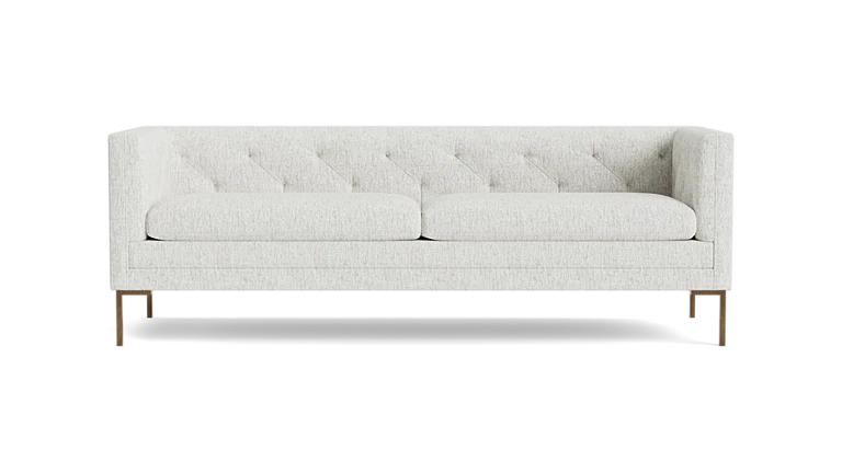 The Sit Tight 90" Sofa, featuring a white tufted design with two seat cushions and wooden legs, is displayed against a plain black background.