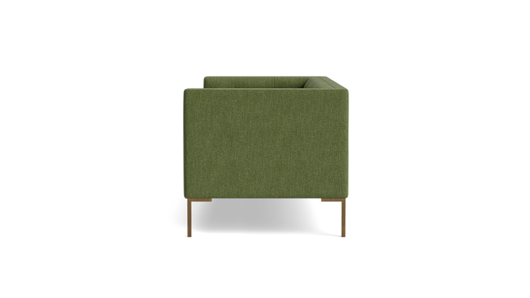 A green Sit Tight 90" Sofa with a minimalist design is displayed in a side view against a black background. It features wooden legs and boasts a boxy shape with clean lines.