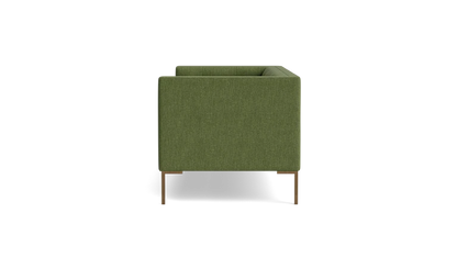 A green Sit Tight 90" Sofa with a minimalist design is displayed in a side view against a black background. It features wooden legs and boasts a boxy shape with clean lines.