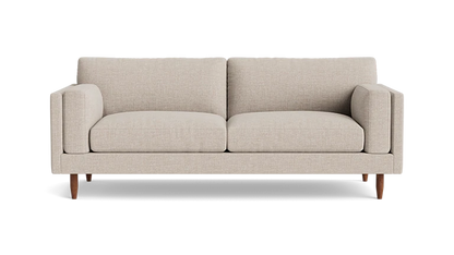 Introducing the "Skinny Fat 85" Sofa Standard Depth": A beige, modern sofa featuring two large cushions and wooden legs, elegantly set against a plain background. This minimalist masterpiece offers a cozy and stylish seating experience.