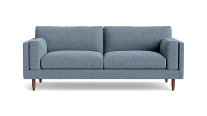 Presenting the Skinny Fat 85" Sofa Standard Depth: a contemporary two-seater with light blue upholstery and wooden legs, viewed from the front. It features clean lines and plush cushions, embodying a minimalist design.