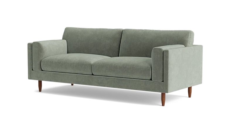 Introducing the Skinny Fat 85" Sofa Standard Depth—a sleek and contemporary sofa in a modern light green hue. This stylish piece includes two seat cushions and two back cushions, complemented by straight armrests and supported by four wooden legs.