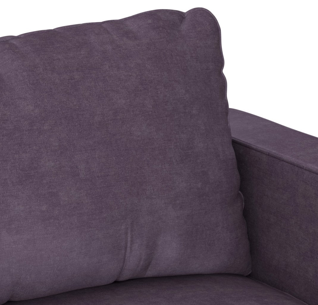 Close-up of the Sactionals - 6 Seats + 8 Sides, upholstered in Amethyst Corded Velvet. The lush purple fabric exudes elegance, while the large cushion looks plush and well-stuffed, promising exceptional comfort. The partial view showcases the armrest and backrest, highlighting its contemporary design.