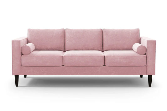 Introducing the Samson Sofa: a pink three-seater sofa featuring square arms and cylindrical bolster pillows. It includes three plush cushions and is supported by elegant dark wooden legs, all showcased against a plain white background.