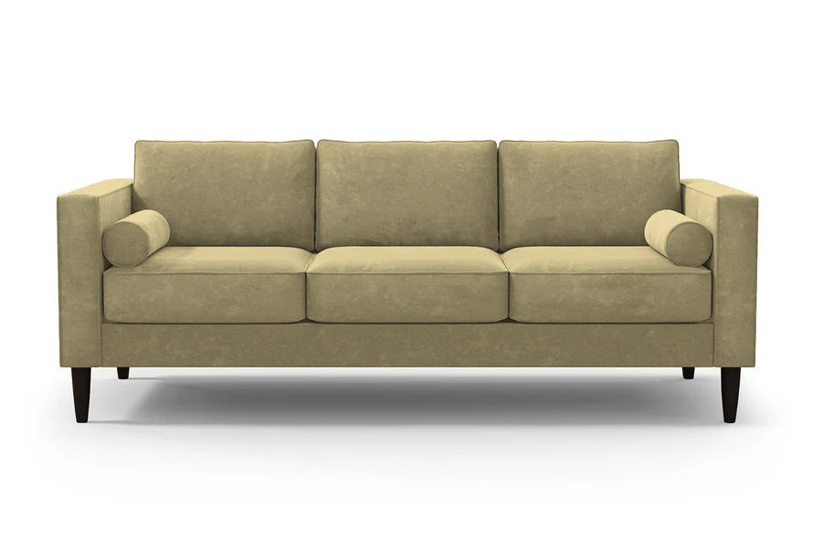 The Samson Sofa is a beige, three-seater with a minimalist design, featuring rectangular cushions and bolster pillows on each end. It has dark wooden legs and is set against a plain white background.