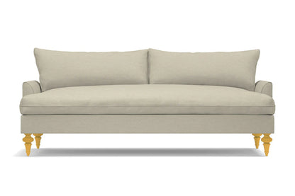 A Saxon Sofa in beige, featuring two large cushions and wooden legs, set against a white background. Its minimalist and modern design provides a clean and sophisticated appearance.