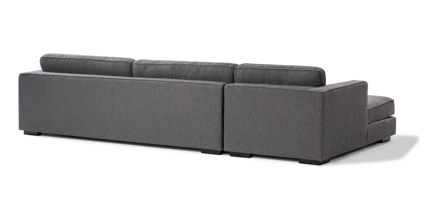 Back view of the Architect 133" Fabric Sofa Sectional Left in Blanc Boucle, featuring a gray L-shape with three large back cushions and dark legs, positioned against a white background.