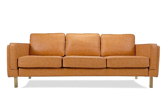 The Albany Sofa, made with vegan leather, features a brown finish and includes three seat cushions along with three back cushions. It boasts wide armrests and stands on four metal legs, all set against a white background.