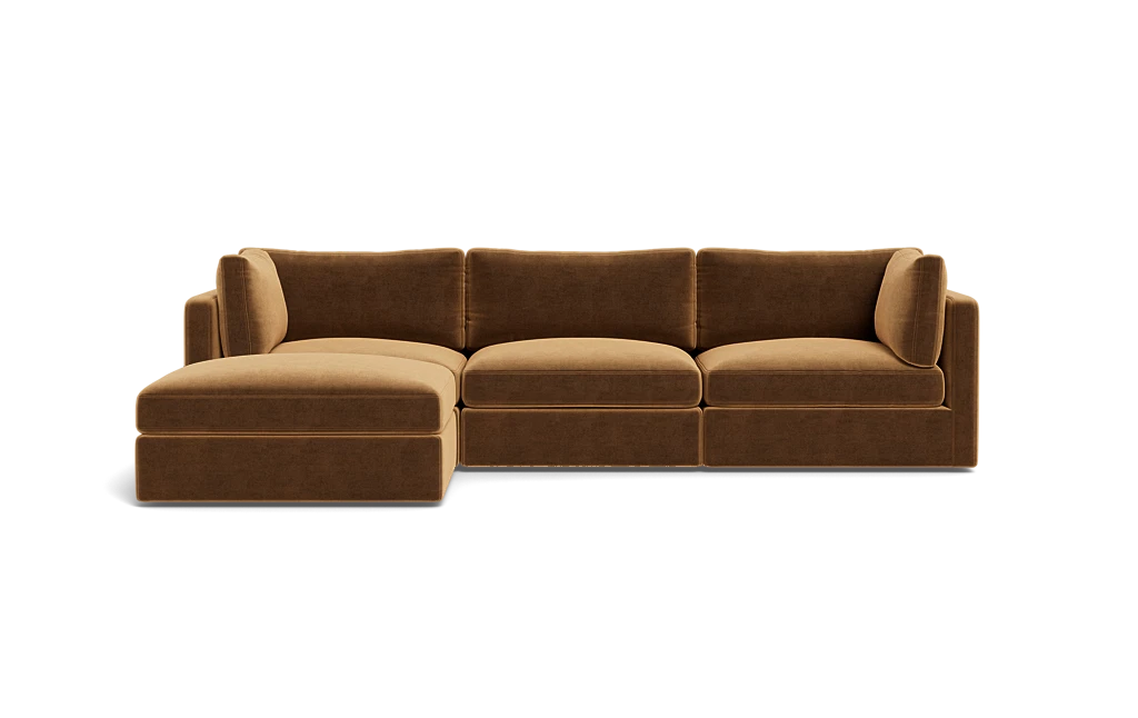 The Tatum Modular 3 Seat Chaise Sectional is a brown sofa with three seat cushions and an extended chaise lounge on the left. It showcases plush back cushions and a modern design, set against a plain black background.