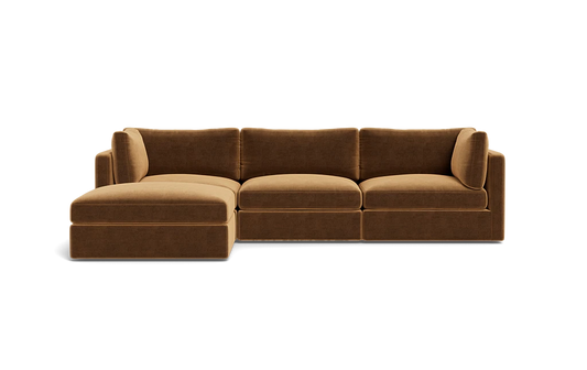 The Tatum Modular 3 Seat Chaise Sectional is a brown sofa with three seat cushions and an extended chaise lounge on the left. It showcases plush back cushions and a modern design, set against a plain black background.