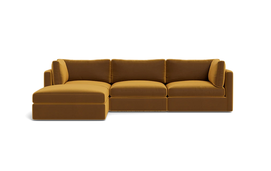 A Tatum Modular 3 Seat Chaise Sectional in mustard yellow, showcasing clean lines and plush cushions against a plain black background, features a left-side chaise for a sleek and modern design.