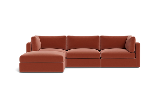 A sleek Tatum Modular 3 Seat Chaise Sectional in a rust hue, featuring a left-side chaise and showcased against a black backdrop. This sectional is designed with plush cushions and embodies a streamlined, minimalist aesthetic.