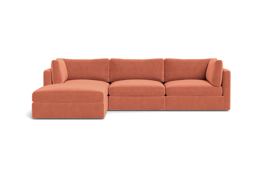 The Tatum Modular 3 Seat Chaise Sectional is a spacious, contemporary sofa featuring a chaise lounge. It's upholstered in an inviting, earthy orange fabric with clean lines and plush cushions, set against a simple black background.