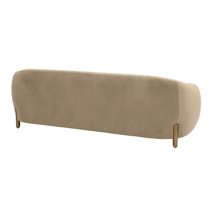 The image showcases the back view of the Lina Sofa by Inspire Me! Home Decor, featuring a beige, modern design with a curved structure and slender gold legs. The smooth and plush upholstery gives it an elegant and luxurious appearance.