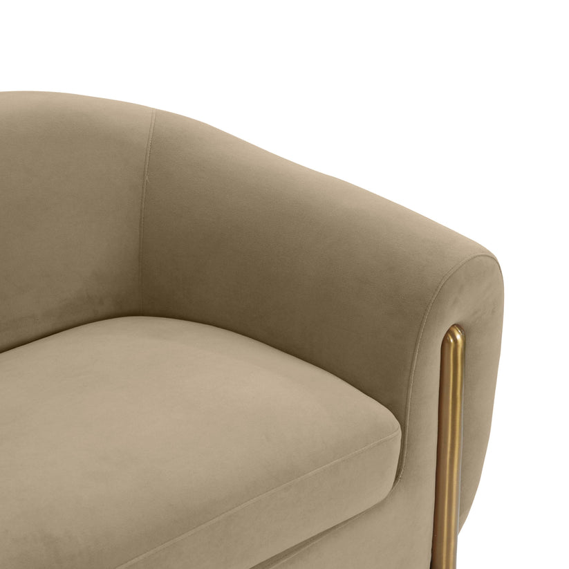 Close-up of the Lina Sofa by Inspire Me! Home Decor, featuring a beige velvet fabric with a curved backrest and gold metal legs.