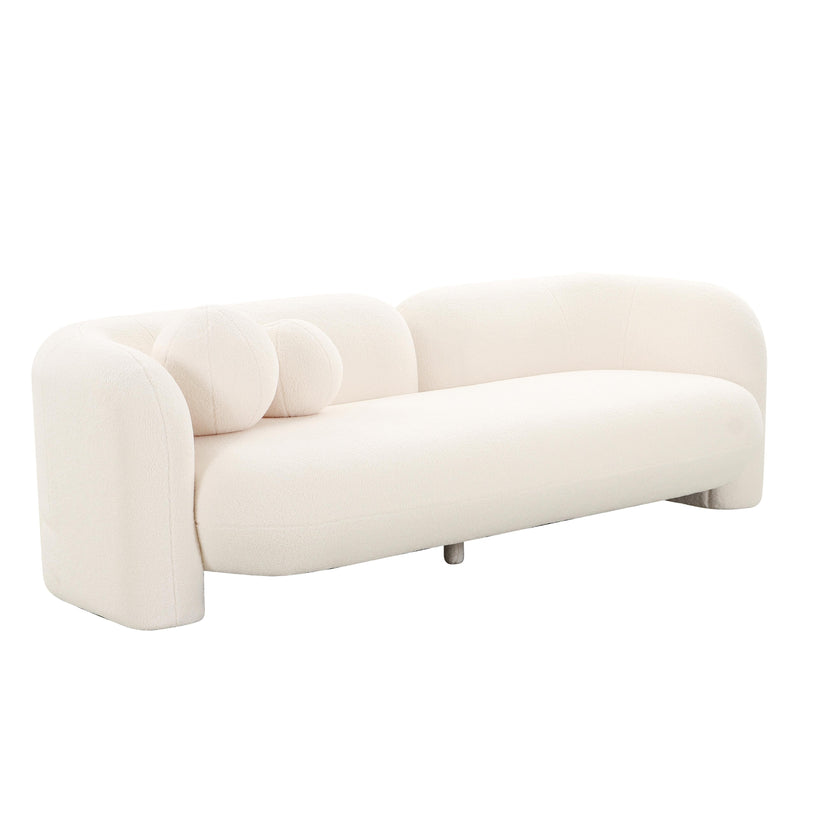 The Amelie Faux Fur Sofa is a modern piece featuring a curved back and armrests, complete with two round cushions. Its sleek and minimalist design brings a stylish touch to any contemporary living space.