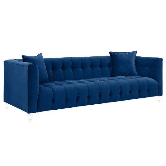 The Bea Velvet Tufted Sofa features a modern design with blue velvet upholstery, a buttoned backrest, and transparent legs. It comes with two matching pillows and plush cushions, providing a comfortable and stylish seating option.