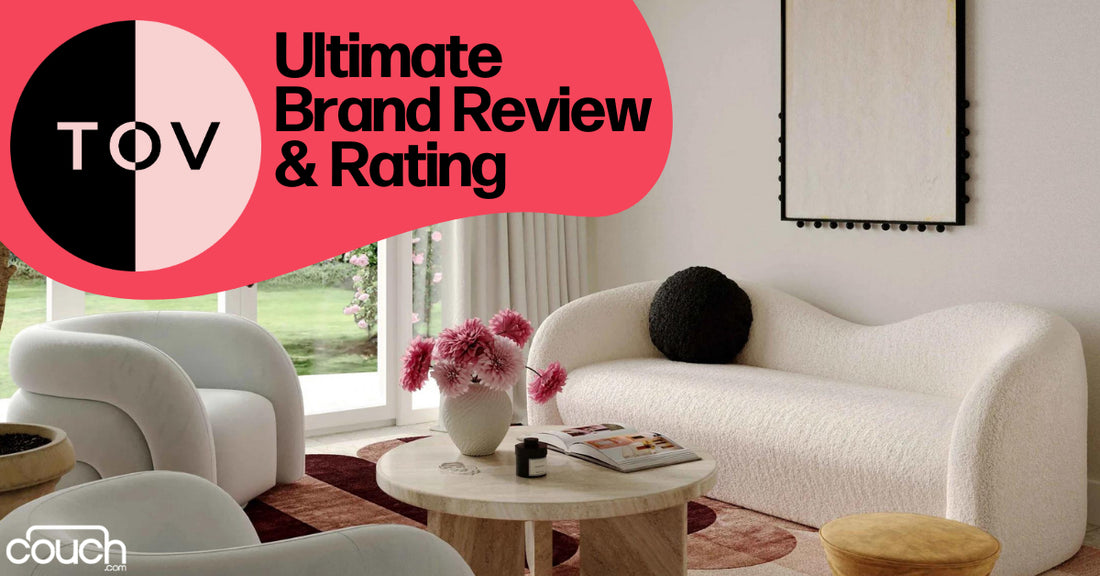 A modern living room featuring a stylish white sofa, a round wooden coffee table with pink flowers, and a large window. The text reads "Ultimate Brand Review & Rating" with "TOV" and "couch.com" logos.