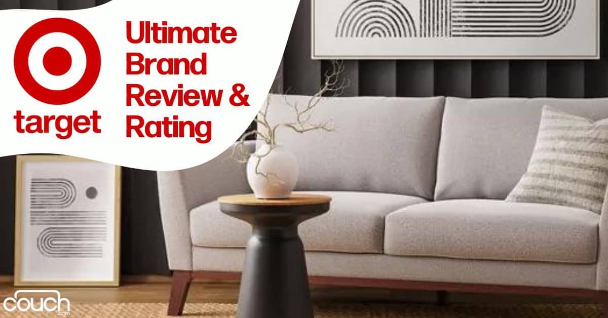 A modern living room featuring a light grey sofa with wooden legs, a small round black table with a minimalist design, a large abstract artwork on the wall, and another smaller artwork leaning against the wall. Text reads "Target Ultimate Brand Review & Rating".